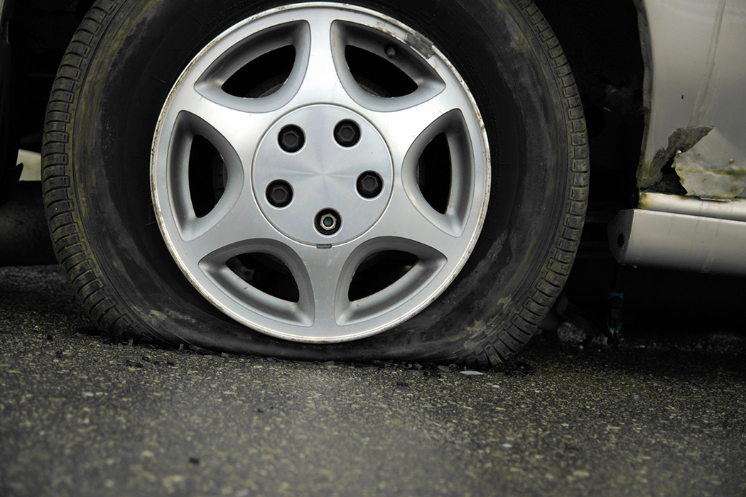 Flat tire and possible rim damage from hitting a pothole